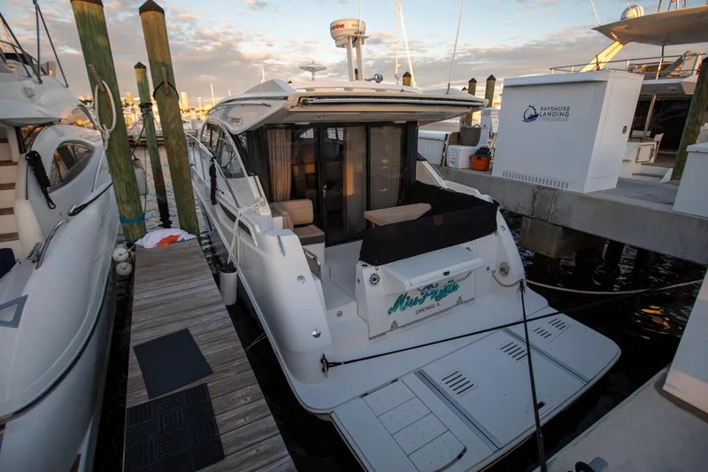 Logan Yacht Photos Pics 2018 Sea Ray Sundancer 400 docked at marina, rear view with open deck.