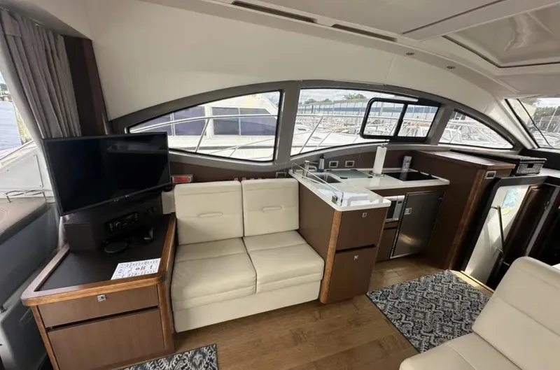 Logan Yacht Photos Pics Interior of 2018 Sea Ray Sundancer 400 yacht with modern seating and kitchenette.