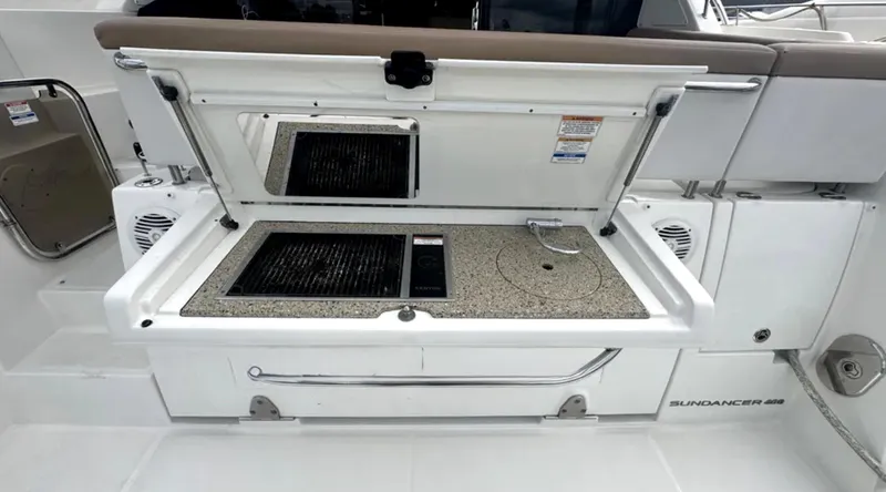 Logan Yacht Photos Pics Outdoor kitchenette on 2018 Sea Ray Sundancer 400 yacht, featuring grill and sink.