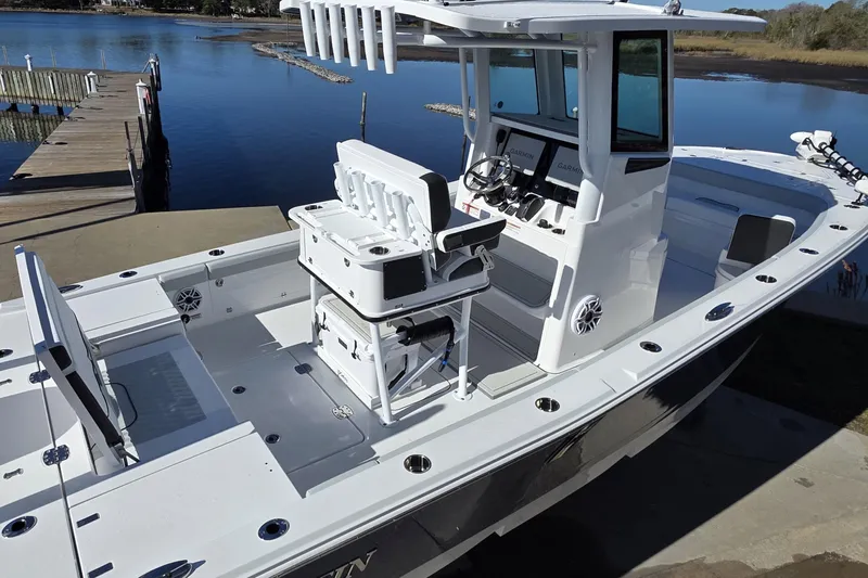  Yacht Photos Pics 2026 Blackfin 262 HB boat docked by serene waters, showcasing modern design and spacious deck.