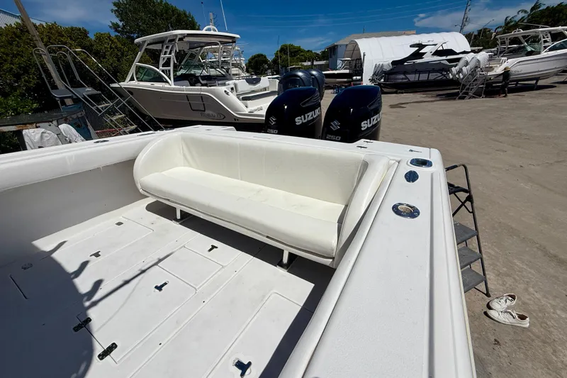  Yacht Photos Pics 2002 Intrepid 323 Cuddy boat with Suzuki engines, docked in a marina.