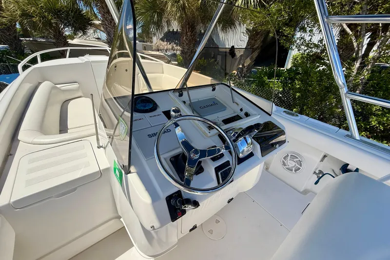  Yacht Photos Pics 2002 Intrepid 323 Cuddy boat cockpit with steering wheel and navigation equipment.