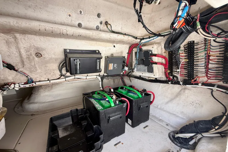  Yacht Photos Pics Electrical system inside a 2002 Intrepid 323 Cuddy boat, featuring batteries and wiring.