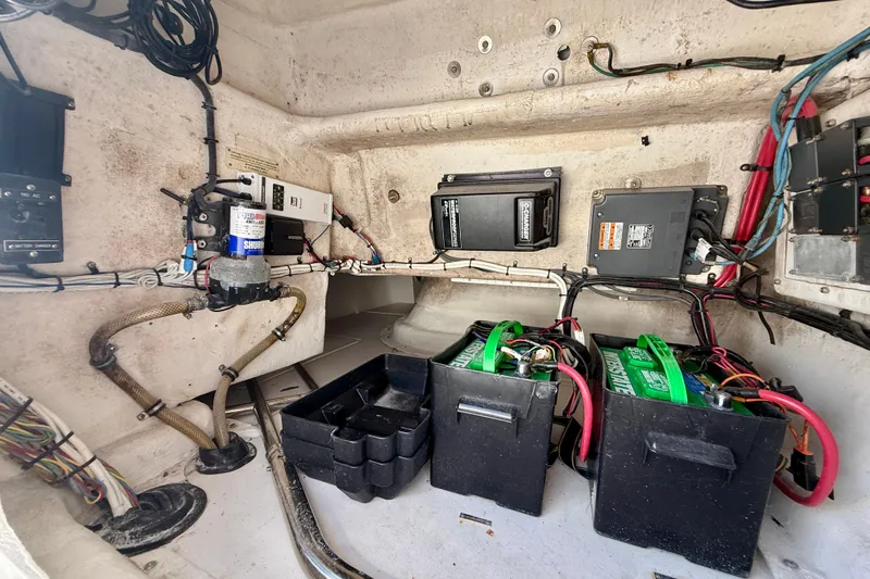  Yacht Photos Pics 2002 Intrepid 323 Cuddy boat interior showing electrical components and battery setup.