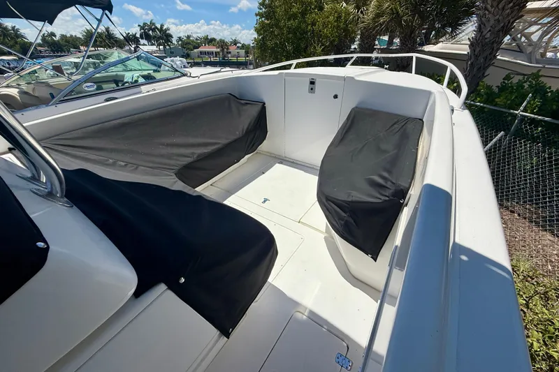  Yacht Photos Pics 2002 Intrepid 323 Cuddy boat interior with covered seating and open deck.