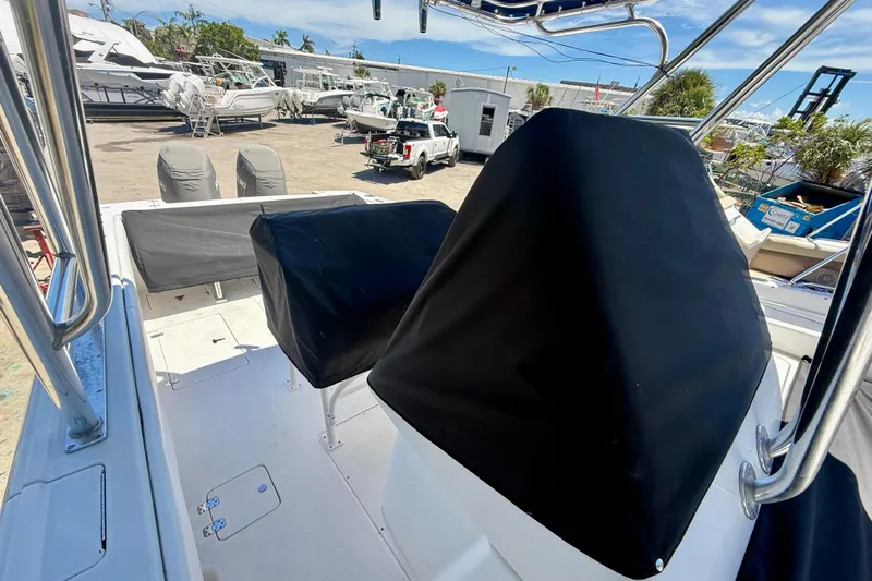  Yacht Photos Pics 2002 Intrepid 323 Cuddy boat interior with covered seats and equipment, docked at a marina.