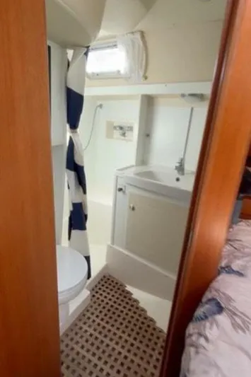 Cygnus Yacht Photos Pics Hallberg-Rassy 46 (2000) yacht bathroom with shower, sink, and toilet.