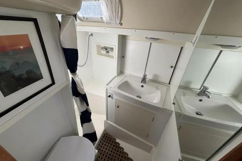Cygnus Yacht Photos Pics Hallberg-Rassy 46 yacht bathroom, featuring sink, mirror, and nautical decor, year 2000 model.
