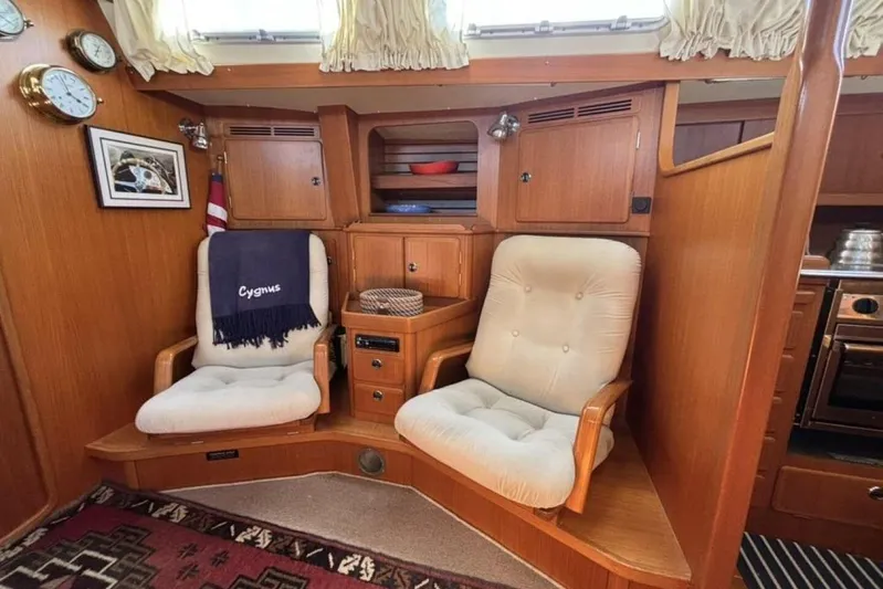 Cygnus Yacht Photos Pics Cozy seating area in a 2000 Hallberg-Rassy 46 yacht interior.