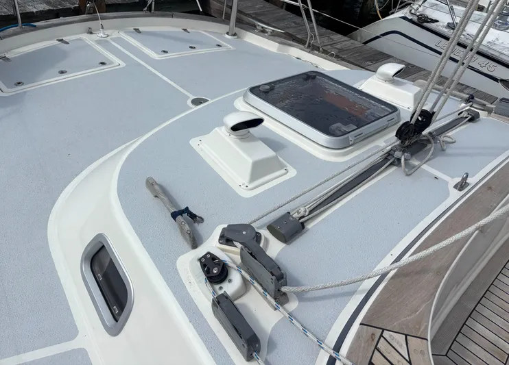 Cygnus Yacht Photos Pics Deck of a 2000 Hallberg-Rassy 46 sailboat with rigging and hatch.