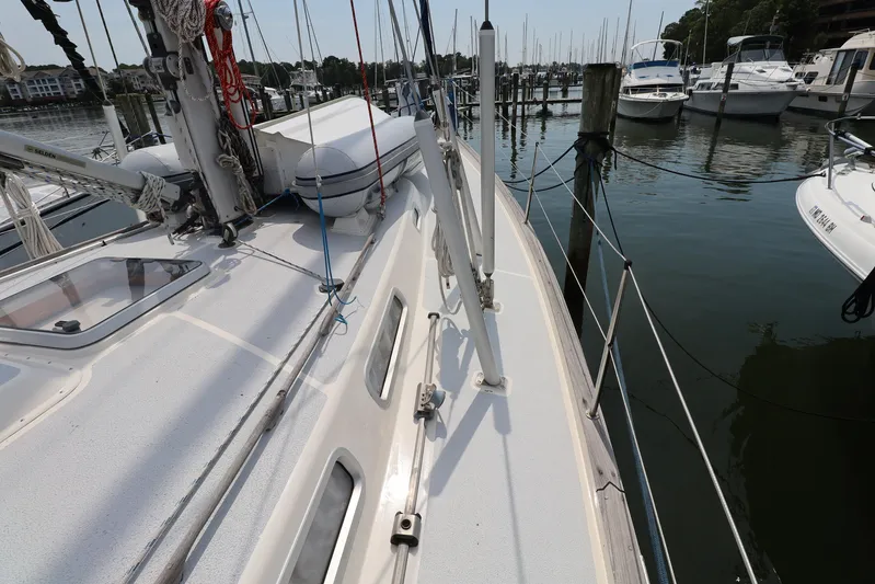 Cygnus Yacht Photos Pics Deck view of a 2000 Hallberg-Rassy 46 sailboat docked at a marina.