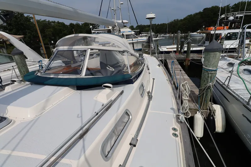 Cygnus Yacht Photos Pics 2000 Hallberg-Rassy 46 sailboat docked at a marina, showcasing deck and cockpit area.