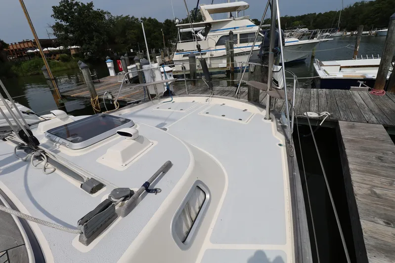 Cygnus Yacht Photos Pics Deck view of a 2000 Hallberg-Rassy 46 yacht docked at a marina.