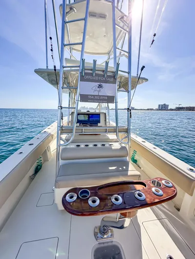 Full Attention Yacht Photos Pics 2012 Contender 39 ST boat interior with fishing rod holders, ocean view, and sunny sky.