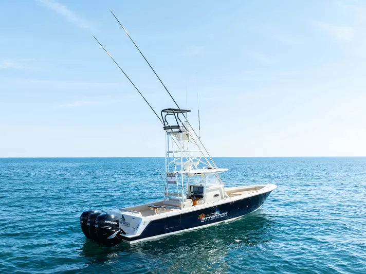 Full Attention Yacht Photos Pics 2012 Contender 39 ST boat on open sea with clear blue sky.