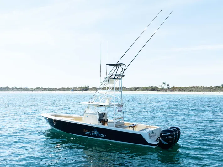 Full Attention Yacht Photos Pics 2012 Contender 39 ST boat on calm ocean near shoreline.
