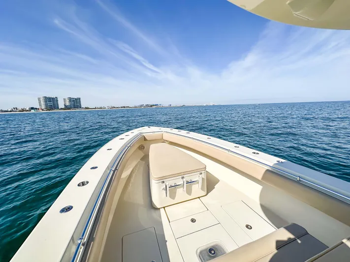 Full Attention Yacht Photos Pics 2012 Contender 39 ST boat on open water, clear sky, distant buildings.