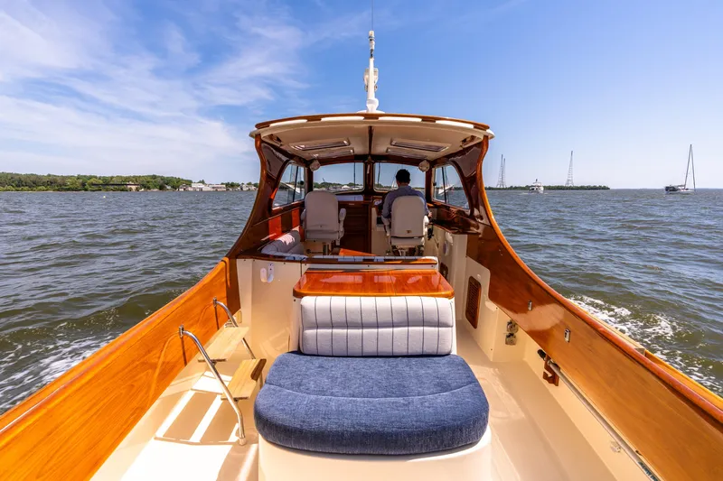 Old Fashioned Yacht Photos Pics 2002 Hinckley Picnic Boat EP cruising on open water under clear blue skies.