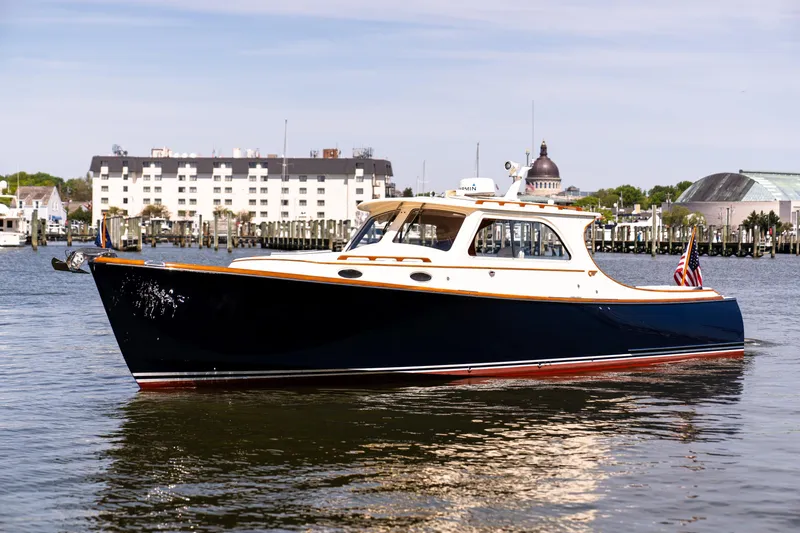 Old Fashioned Yacht Photos Pics 2002 Hinckley Picnic Boat EP on calm water near a marina.