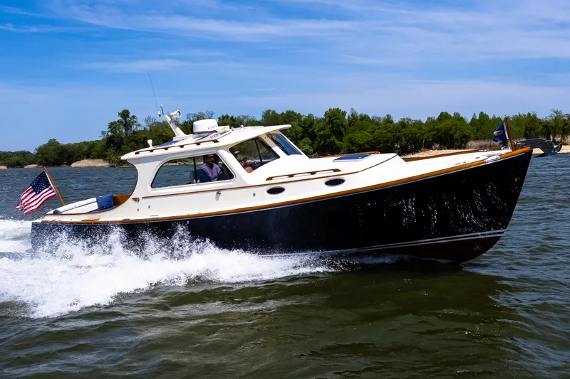Old Fashioned Yacht Photos Pics 2002 Hinckley Picnic Boat EP cruising on a sunny day with American flag.