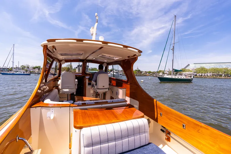 Old Fashioned Yacht Photos Pics 2002 Hinckley Picnic Boat EP on water, sunny day, marina in background.