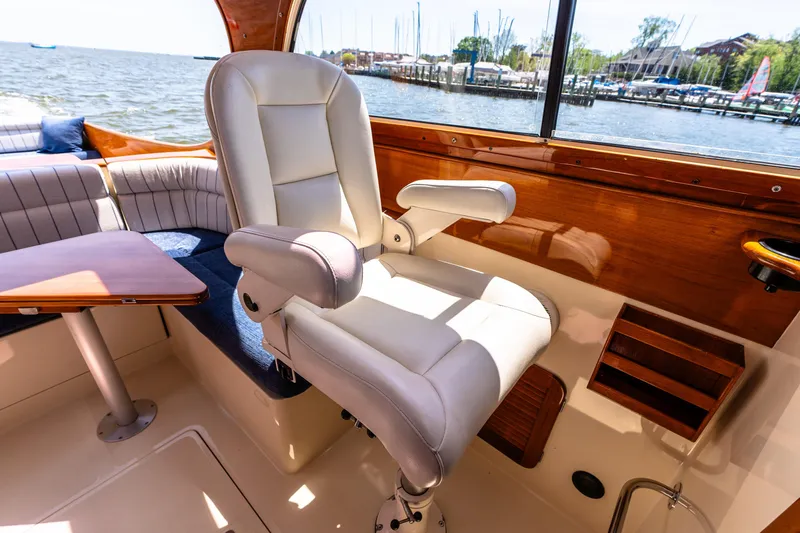 Old Fashioned Yacht Photos Pics Captain's chair on 2002 Hinckley Picnic Boat EP, overlooking marina and water.