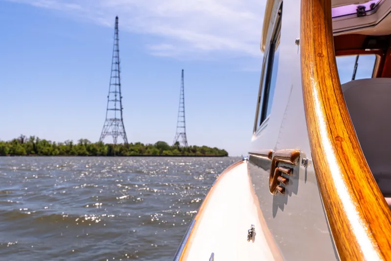 Old Fashioned Yacht Photos Pics 2002 Hinckley Picnic Boat EP cruising on a sunny day with radio towers in the background.