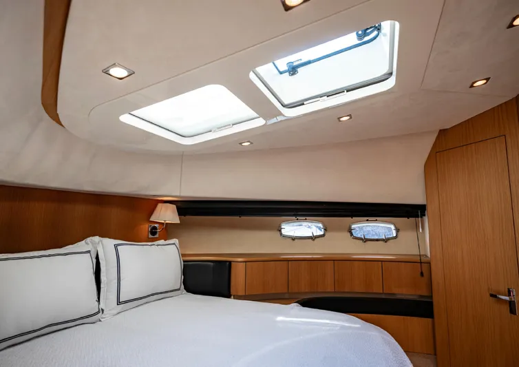  Yacht Photos Pics Luxurious cabin interior of 2010 Fairline Squadron 78 yacht with skylights and elegant bedding.