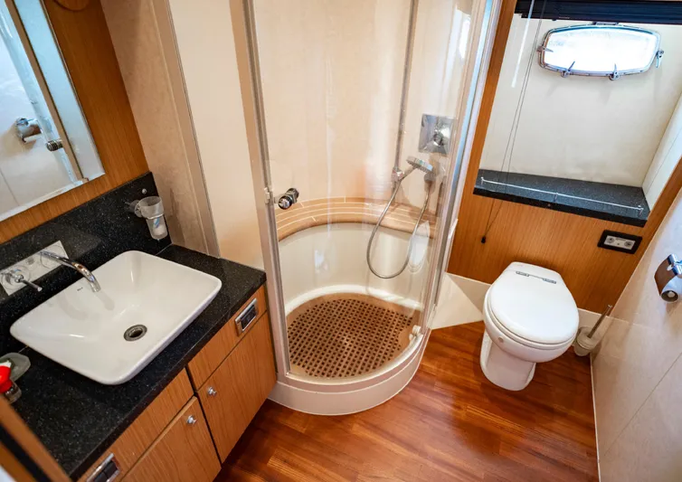  Yacht Photos Pics Luxurious bathroom on 2010 Fairline Squadron 78 yacht with shower, sink, and toilet.
