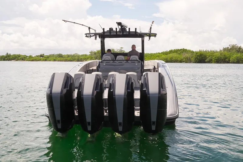  Yacht Photos Pics 2025 Midnight Express 43' Open boat with five powerful outboard engines on a calm waterway.
