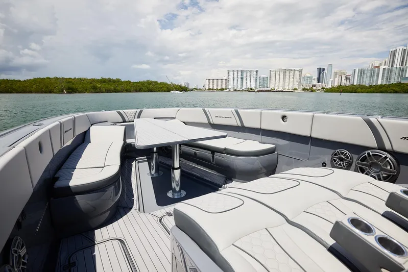  Yacht Photos Pics Luxurious 2025 Midnight Express 43' Open boat interior with sleek seating and table, city skyline view.