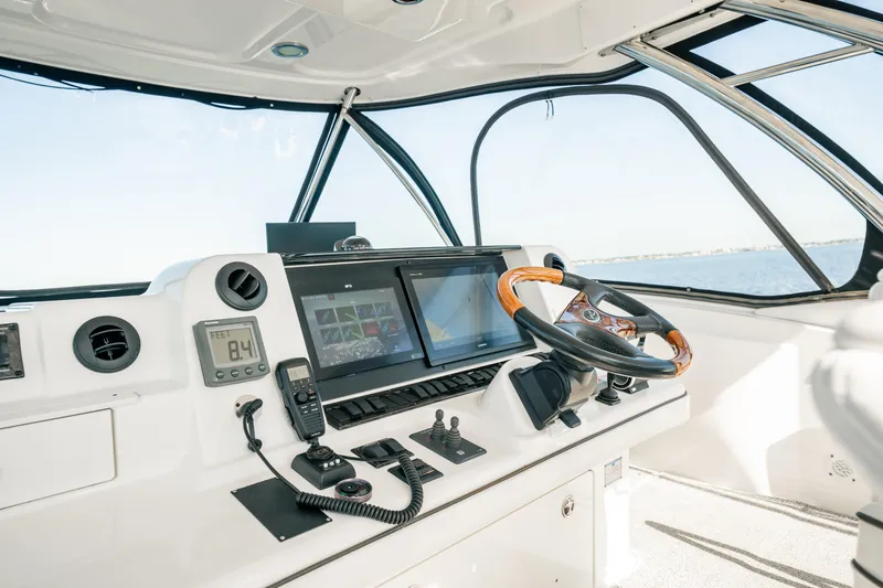 Love & Luck II Yacht Photos Pics 2007 Sea Ray 580 Sedan Bridge helm with modern navigation equipment and steering wheel.
