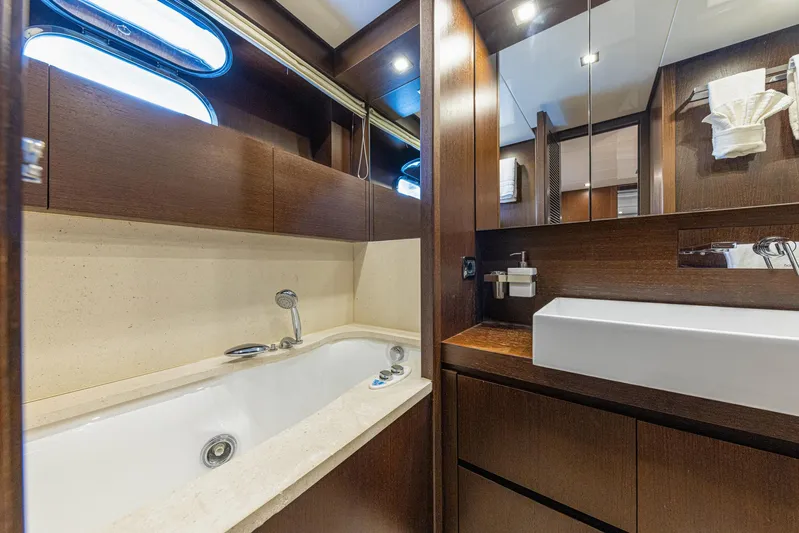  Yacht Photos Pics Luxurious bathroom in 2008 Sanlorenzo SL88 yacht with modern fixtures and elegant wood finishes.
