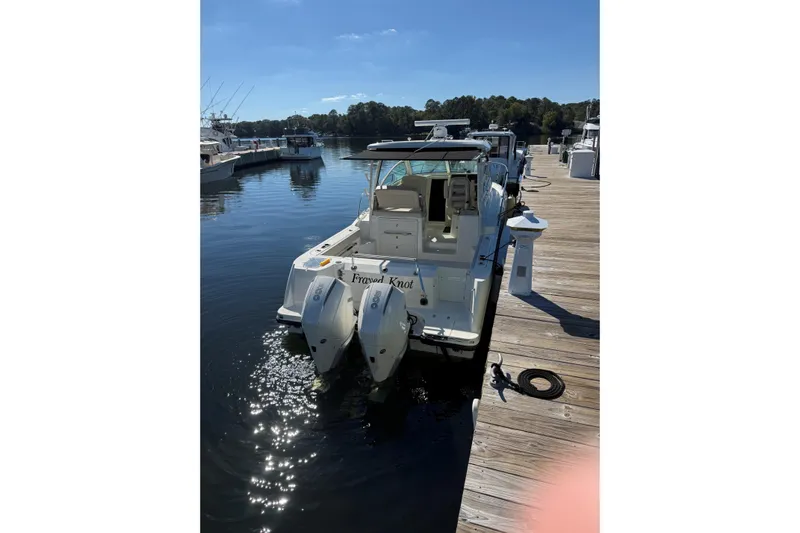  Yacht Photos Pics 2019 Boston Whaler 315 Conquest docked at a marina on a sunny day.