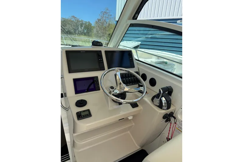  Yacht Photos Pics 2019 Boston Whaler 315 Conquest helm with modern navigation displays and controls.