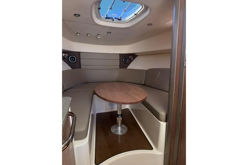  Yacht Photos Pics 2019 Boston Whaler 315 Conquest cabin interior with round table and seating.