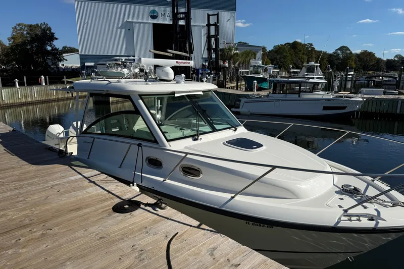  Yacht Photos Pics 2019 Boston Whaler 315 Conquest docked at marina under clear blue sky.