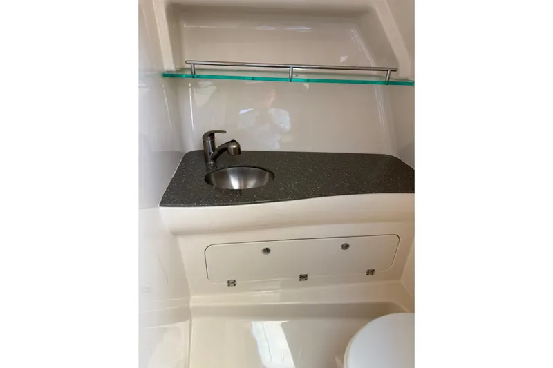  Yacht Photos Pics 2019 Boston Whaler 315 Conquest bathroom with sink, countertop, and storage cabinet.