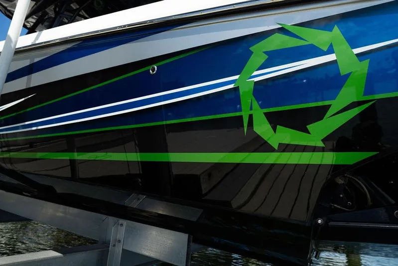  Yacht Photos Pics 2022 Fountain 34 SC boat with blue and green graphics on the hull.