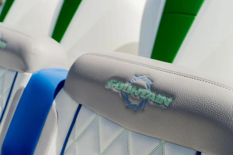  Yacht Photos Pics 2022 Fountain 34 SC boat seats with logo, featuring blue and green accents.