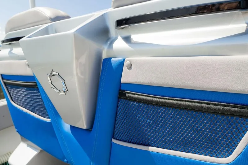  Yacht Photos Pics 2022 Fountain 34 SC boat interior with blue and white seating and mesh storage pockets.