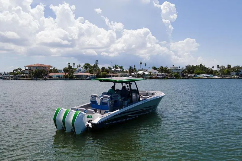  Yacht Photos Pics 2022 Fountain 34 SC boat on calm water under a cloudy sky.