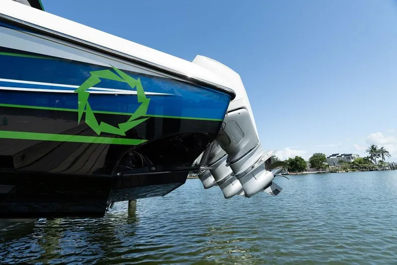  Yacht Photos Pics 2022 Fountain 34 SC boat with triple outboard motors on a sunny day.