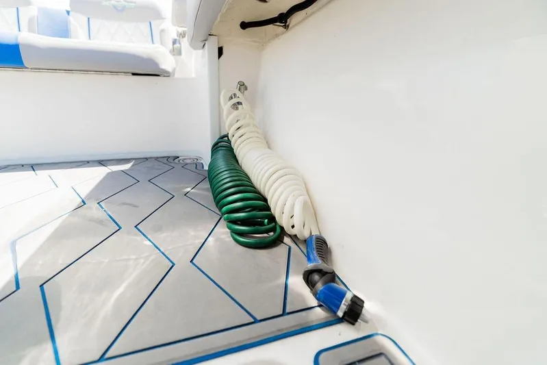  Yacht Photos Pics Coiled hoses on 2022 Fountain 34 SC boat deck with patterned flooring.