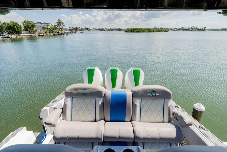  Yacht Photos Pics Luxury seating on 2022 Fountain 34 SC boat overlooking serene waterway.