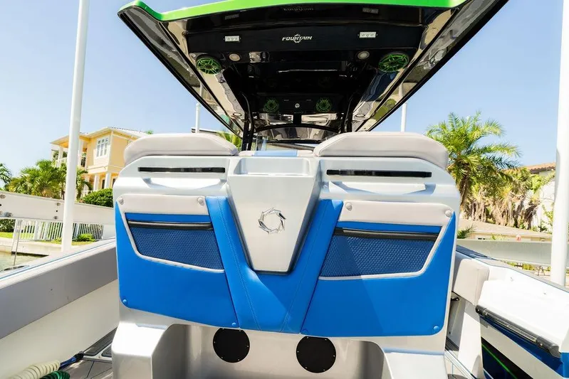  Yacht Photos Pics 2022 Fountain 34 SC boat interior with blue and white seating, luxury design.