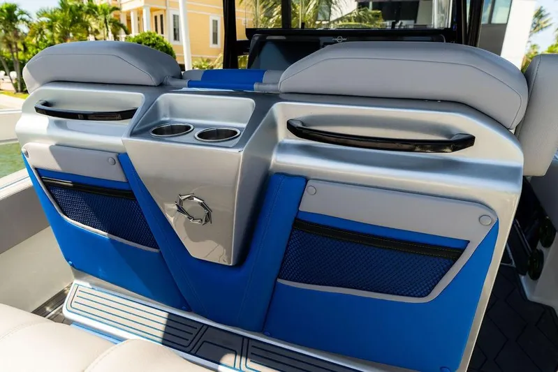  Yacht Photos Pics 2022 Fountain 34 SC boat interior with blue seating and cup holders.
