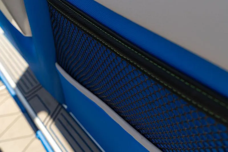 Yacht Photos Pics Close-up of 2022 Fountain 34 SC boat interior with blue mesh pocket detail.