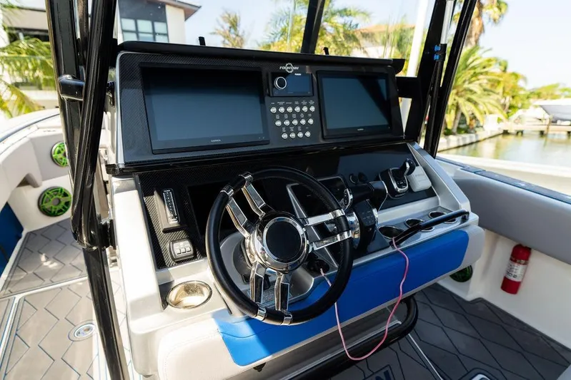  Yacht Photos Pics 2022 Fountain 34 SC boat dashboard with modern controls and steering wheel.