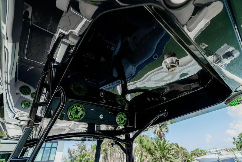  Yacht Photos Pics 2022 Fountain 34 SC boat interior with green speakers and sleek design.